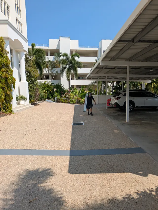 Wish You Were Clear technician carrying equipment at a Cairns resort property